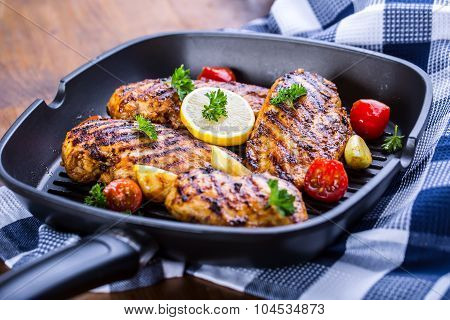 Grilled chicken breast in different variations with cherry tomatoes, green French beans, garlic, her