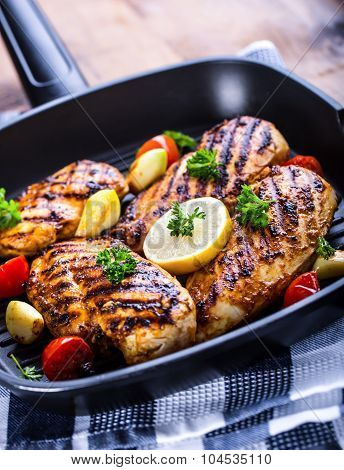 Grilled chicken breast in different variations with cherry tomatoes, green French beans, garlic, her
