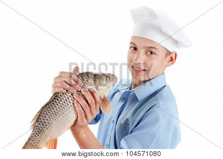 Young Chef Holding A Fish Carp On White Background