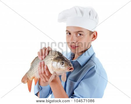 Young Boy Prepare A Fish Carp On White Background
