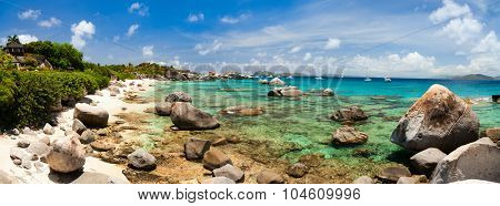 Panorama of a picture perfect beach with white sand, turquoise ocean water and blue sky at British Virgin Islands in Caribbean