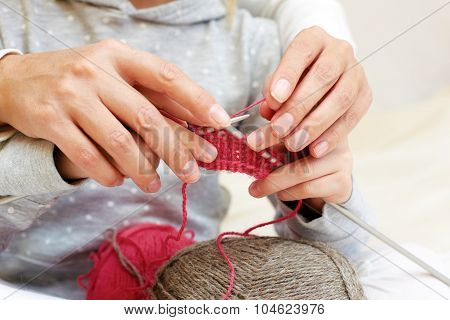 Mom Teaches A Child To Knit. Hands With Needles Close Up