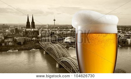 Glass of beer with view of Koeln on background, Germany. Header for website