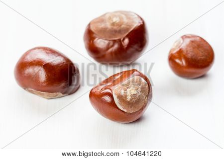 Chestnuts On A White Wooden Background