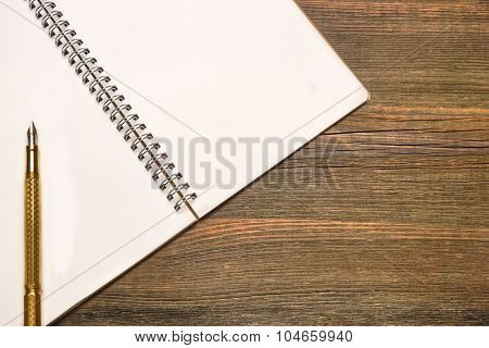 Notebook With Blank Page  And Golden Pen  On Wood Table