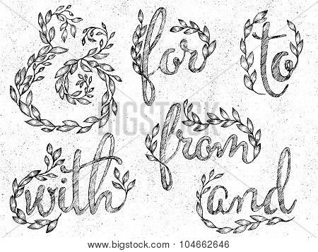 Ink drawn ampersand made of leaves and branches and catchwords in leaves wreaths