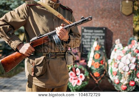 Unidentified reconstructor dressed as Soviet soldier standing on