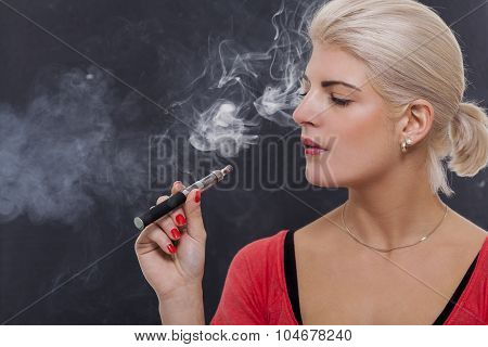 Stylish Blond Woman Smoking An E-cigarette
