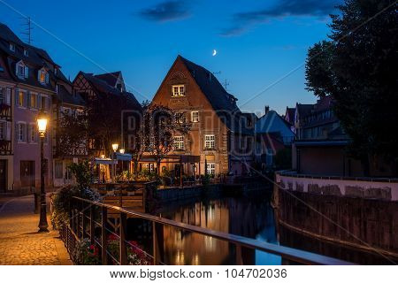 Traditional french houses on the side of chanel Petite Venise, Colmar, France, at night.