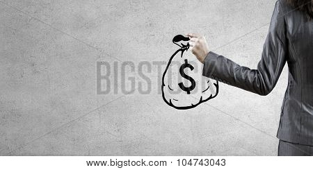 Back view of businesswoman holding drawn money bag