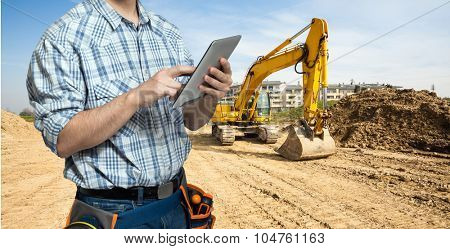 Worker using a tablet in a construction site