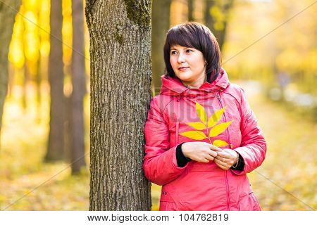 woman with autumn leaves in hand