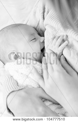 Mother Breastfeeding The Newborn Smiling