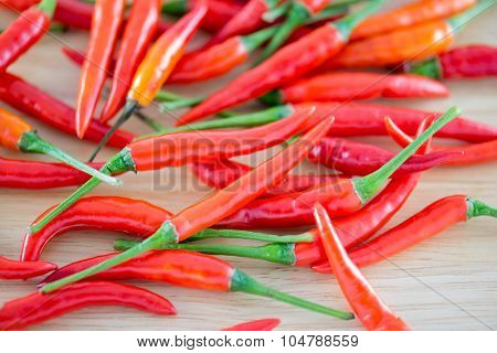 Red Chillis on wooden top