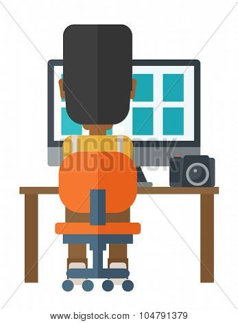 Back view of African American photographer using computer at his workplace vector flat design illustration isolated on white background. Vertical layout.