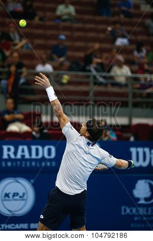 KUALA LUMPUR, MALAYSIA - OCTOBER 02, 2015: Spain's David Ferrer tosses the ball to serve in his match at the Malaysian Open 2015 tennis tournament held at the Putra Stadium, Malaysia.
