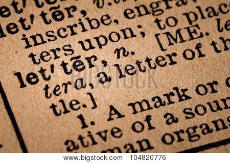 Close-up Of An Opened Dictionary Showing The Word Letter