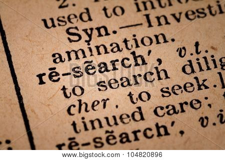 Close-up Of An Opened Dictionary Showing The Word Research