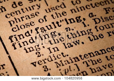 Close-up Of An Opened Dictionary Showing The Word Finding