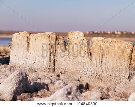 Petrified Salt Acted On Wooden Boards In Dry Estuary, Selective Focus. Water Has Receded Far Into Th