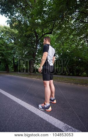 healthy athlete man jogging at morning on empty  roat in the city