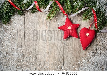 Christmas Border. Tree branches with stars, heart and snow on wooden board