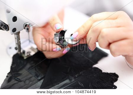 Sewing on a machine.