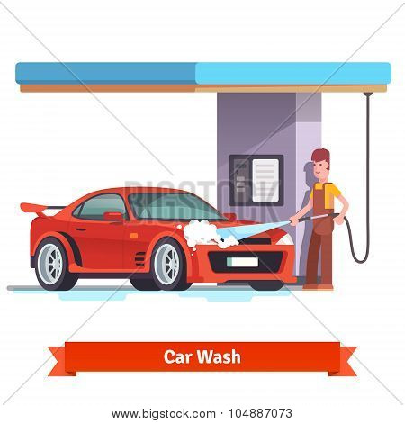 Car wash specialist washing red sports car