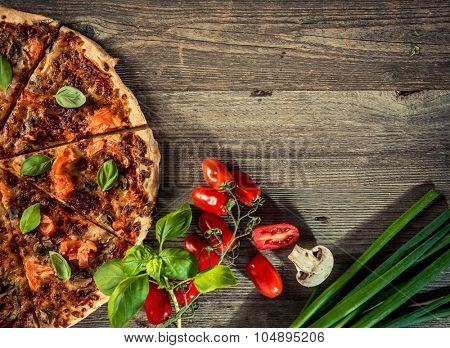Vegetarian italian pizza with mushrooms on a wooden background with space for text
