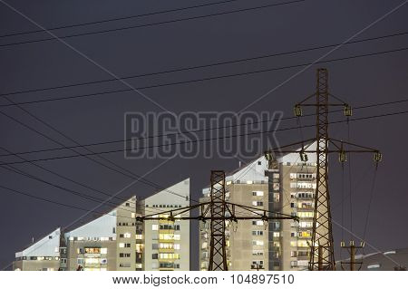 High power electricity poles in urban area at night
