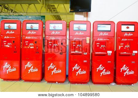 KUALA LUMPUR, MALAYSIA - MAY 02, 2014:  AirAsia self check-in kiosks. AirAsia Berhad is a Malaysian low-cost airline headquartered near Kuala Lumpur, Malaysia