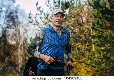 middle-aged man running in autumn Park