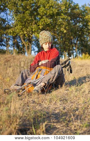 Young Girl Sitting On The Grass.