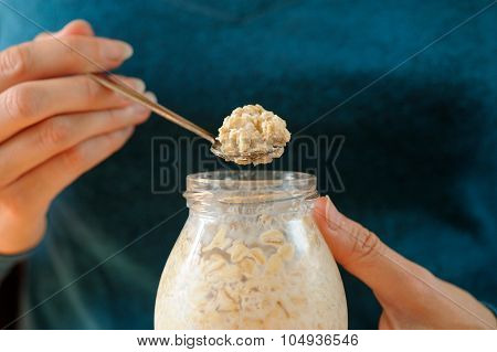 Woman's Slender Hands Holding Glass Jar And Spoon With Overnight Oats Selective Focus