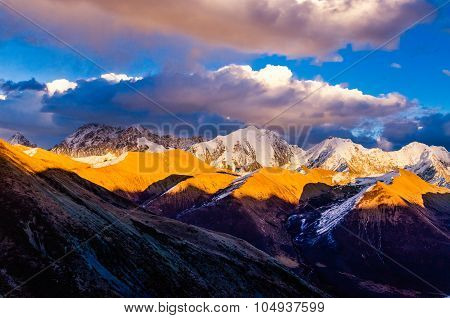 View From St. Moritz In Switzerland: High Snow And Ice Capped Alpine Mountain Range With Red Illumin