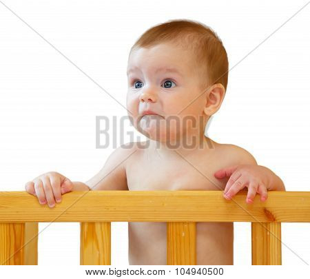 Sad Half-year-old Baby Holding The Side Cot