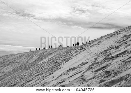 View from Dune of Pilat or Pyla with crowd of people walking on the top - the largest sand dune in Europe Aquitaine France