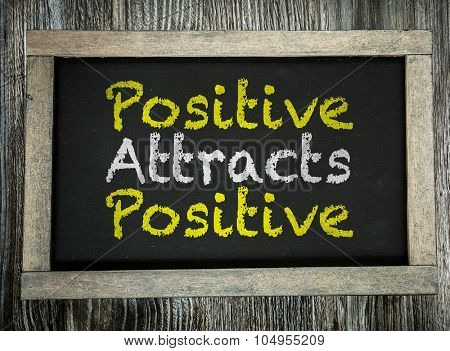 Positive Attracts Positive written on chalkboard