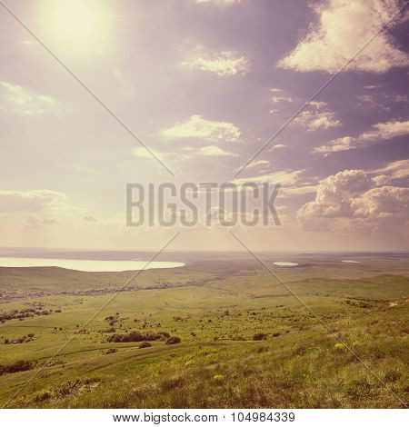 Photo Of Beautiful Landscape With Grassy And Land Lake Under Sunny Skies In Vintage Style
