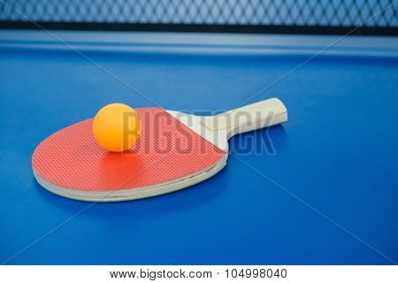Pingpong Racket And Ball On A Blue Pingpong Table