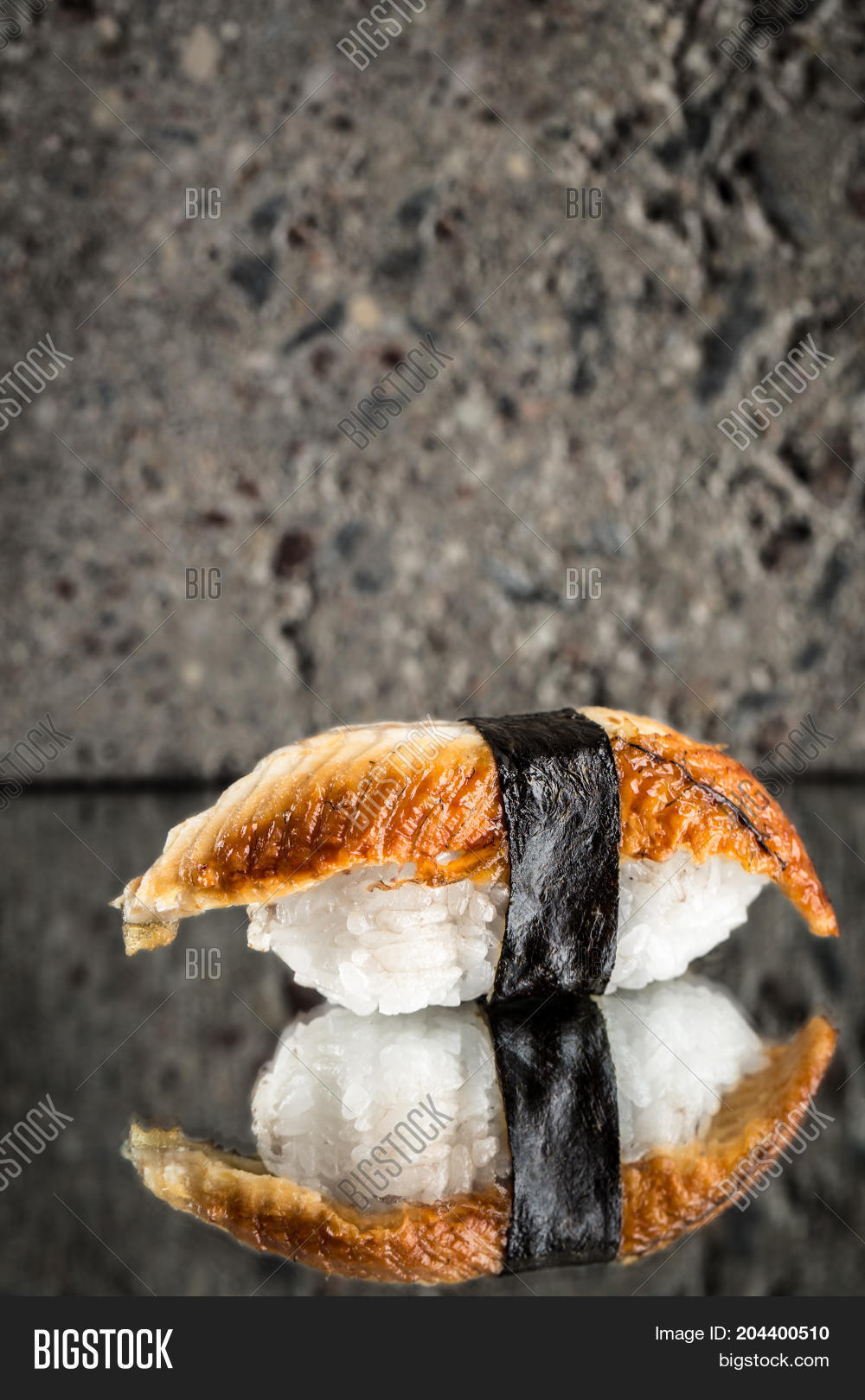 nigiri sushi with eel over concrete background