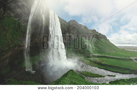 famous Seljalandsfoss waterfall in southern Iceland. treking in Iceland. Travel and landscape photography concept
