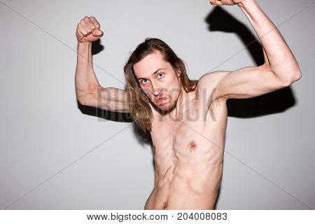 Aggressive gangster male showing off his muscles. Self-satisfied man, sports guy bragging about courage, power concept