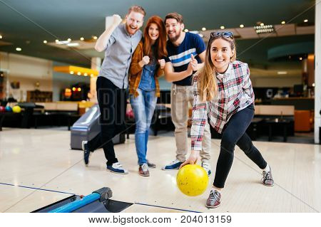 Friends having fun while bowling and speding time together