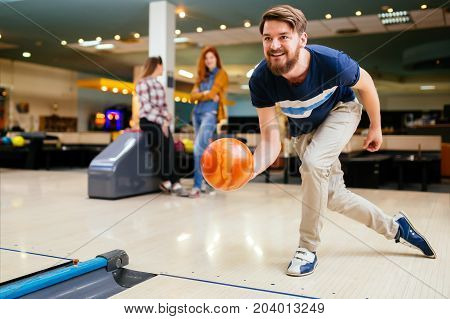 Friends having fun while bowling and speding time together