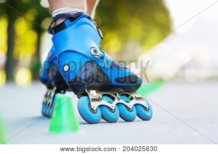 Inline Roller Skater On A Slalom Course