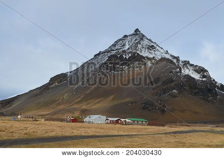 Farm houses located at the base of Mount Stapafell in iceland.