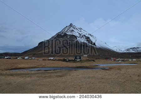 Village of Arnastapi in Iceland at the base of Mount Stapafell.