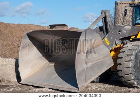 Big shovel of a big bulldozer on a sunny day