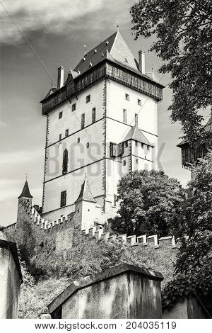 Karlstejn is a large gothic castle founded 1348 by Charles IV in Czech republic. Ancient architecture. Travel destination. Black and white photo.